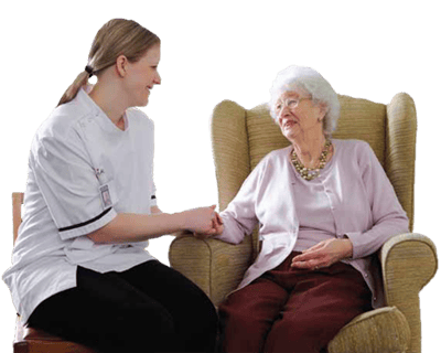 Caregiver engaging with a senior resident in a cozy chair