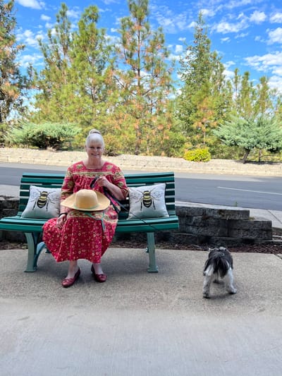 A resident enjoying the outdoors with a small dog