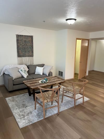 Cozy living room area with sofa and chairs