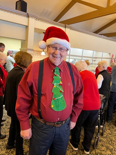 Resident celebrating in festive attire at a holiday event