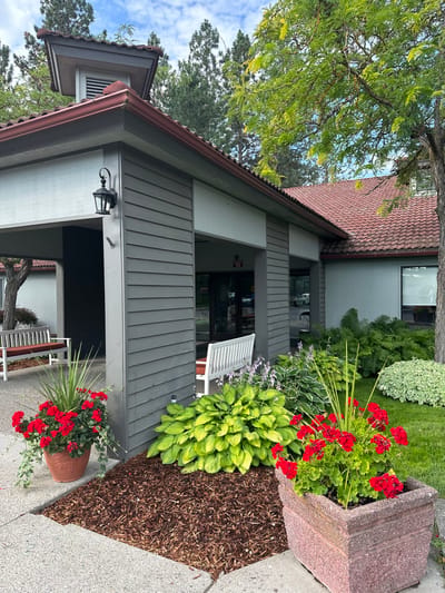 Front exterior of Fairwood Retirement Village with landscaped flowers