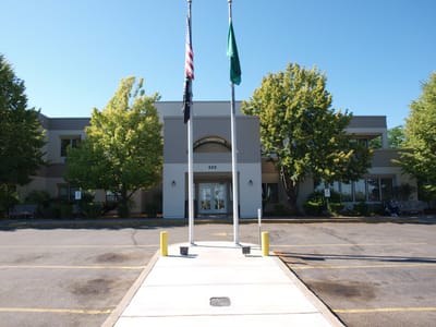 Facade of Spokane Veterans Home with flags