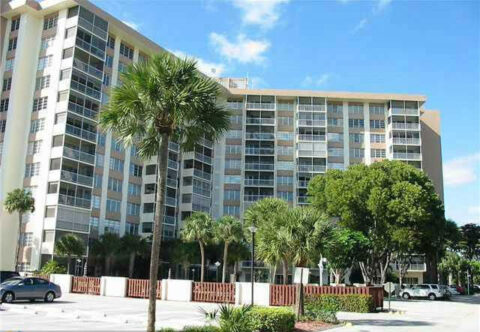 Exterior view of Country Club Tower with palm trees