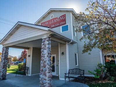 Exterior view of Elk Creek Senior Living Apartments with leasing sign