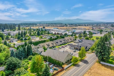 Aerial view of a senior living facility with landscaped grounds