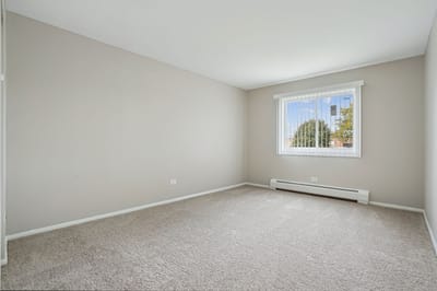 Empty interior room with neutral walls and carpet