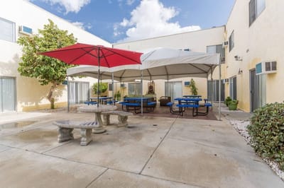 Outdoor courtyard with shaded seating and tables