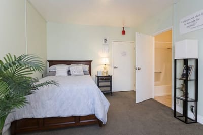 A cozy private resident room with a bed and decor