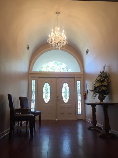 Entrance hallway with chandelier and floral arrangement