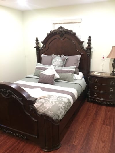 Stylishly decorated private resident room with a bed and nightstand