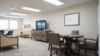 Interior common area with seating and a TV