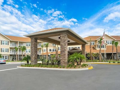 Front entrance of a senior living facility with landscaped area