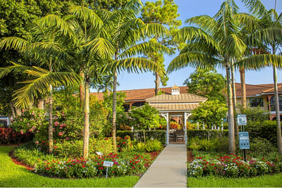 Lush gardens and pathways leading to the entrance