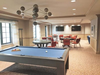 Interior view of a common area with dining and pool table