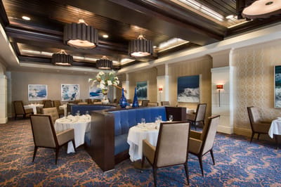 Elegant dining area with decorative lighting and artwork