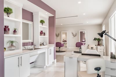 Hair salon interior with styling stations and plants