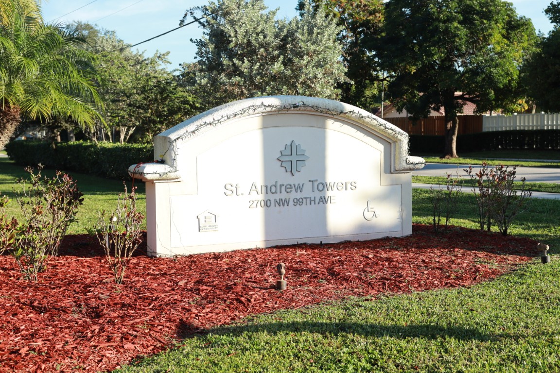 Sign for St. Andrew Towers with landscaped garden