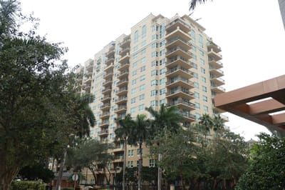 Exterior view of a senior living facility with palm trees