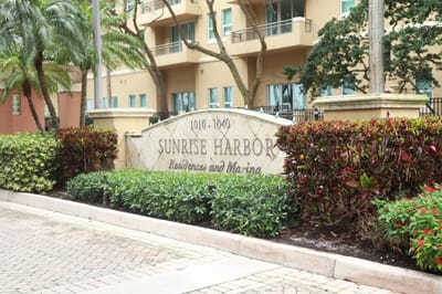 Sign for Sunrise Harbor with lush landscaping
