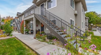 Exterior view of The Lillian Apartments with a garden