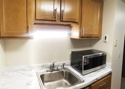 A kitchen area with a sink and microwave