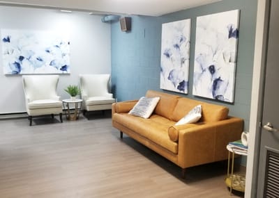 Cozy lounge area with comfortable seating and artwork