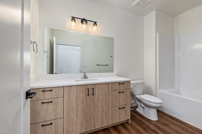 Modern bathroom with wooden vanity and mirror