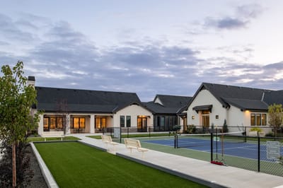 Exterior view of a senior living facility with landscaped area