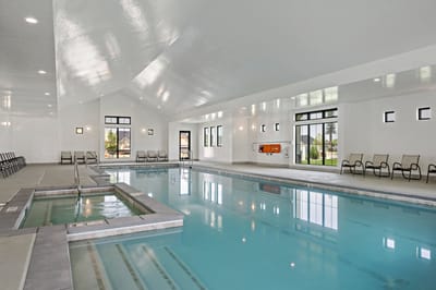 Indoor swimming pool area with lounge chairs