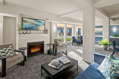 Bright common area with seating and fireplace