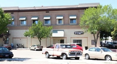 Exterior view of Van Engelen facility with parked cars