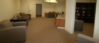 Interior view of a common area with seating and bookshelves