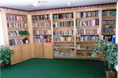 Bookshelves filled with books in a common area