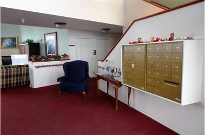Interior view of a common area with mailboxes and seating
