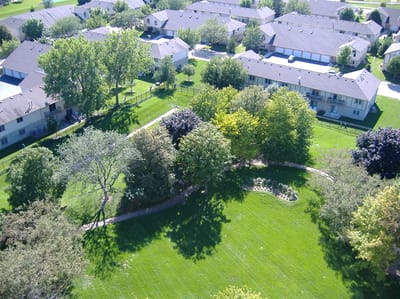 Aerial view of landscaped outdoor space with apartments