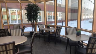 Bright sunroom with tables and chairs