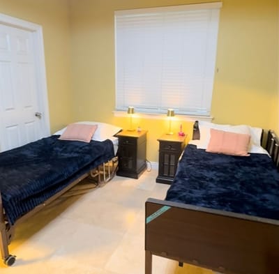 Shared resident room with two beds and bedside tables