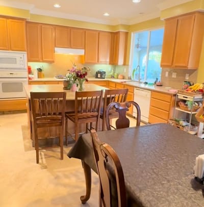 Bright communal kitchen area with wooden cabinets