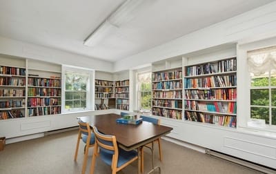 Interior of a library filled with books and a table