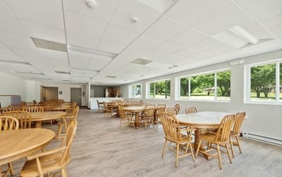Bright dining area with wooden tables and chairs