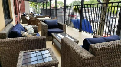 Outdoor seating area with wicker chairs and tables