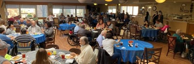 Residents dining together in a community dining room
