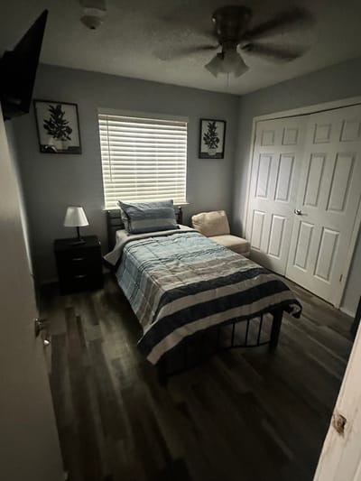 A private resident room with a bed and chair