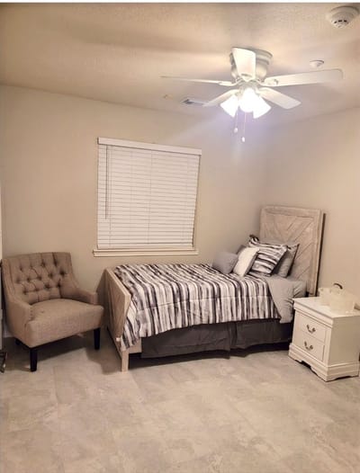 Cozy private room with a bed and armchair