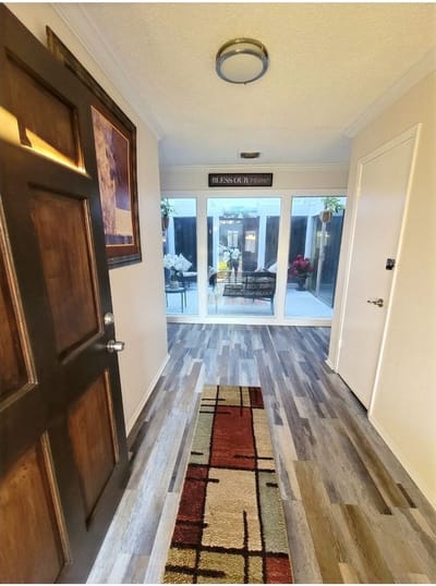 Interior hallway leading to a sunlit space