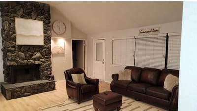 Cozy living room with stone fireplace and clock