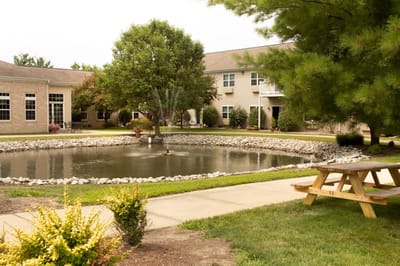 Serene outdoor pond view with seating area