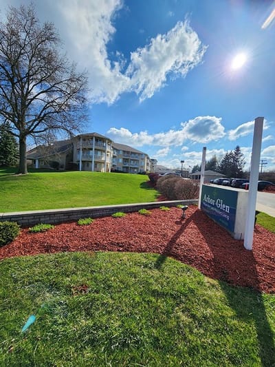 Exterior view of Arbor Glen with green landscaping