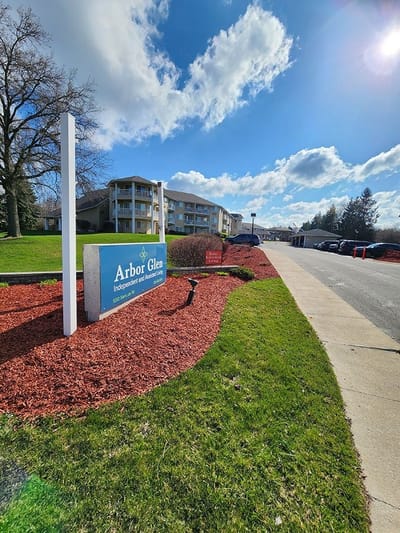 Exterior view of Arbor Glen facility with landscaping