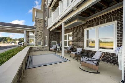 Outdoor seating area with chairs and flowers